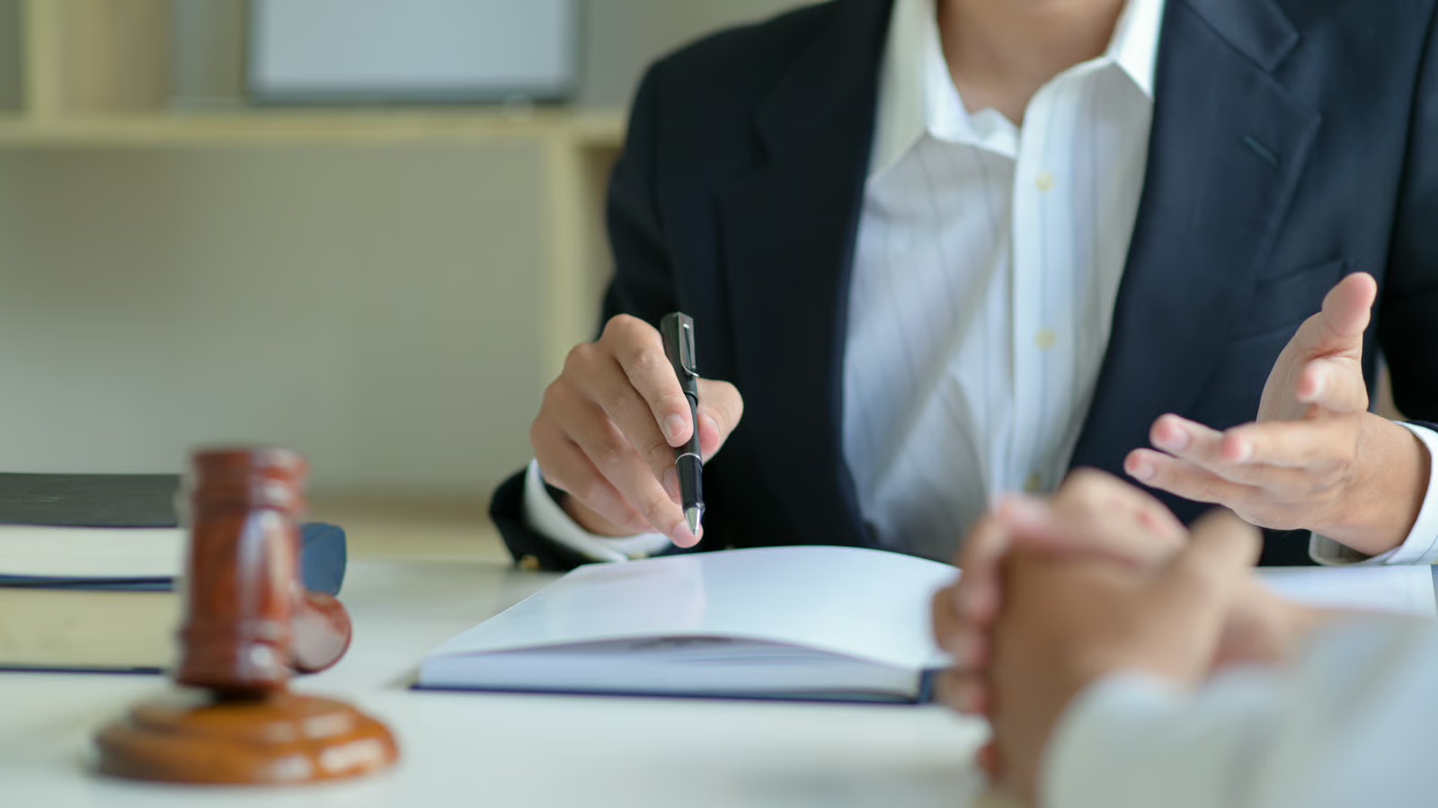 Discussion around a table with documents and a gavel